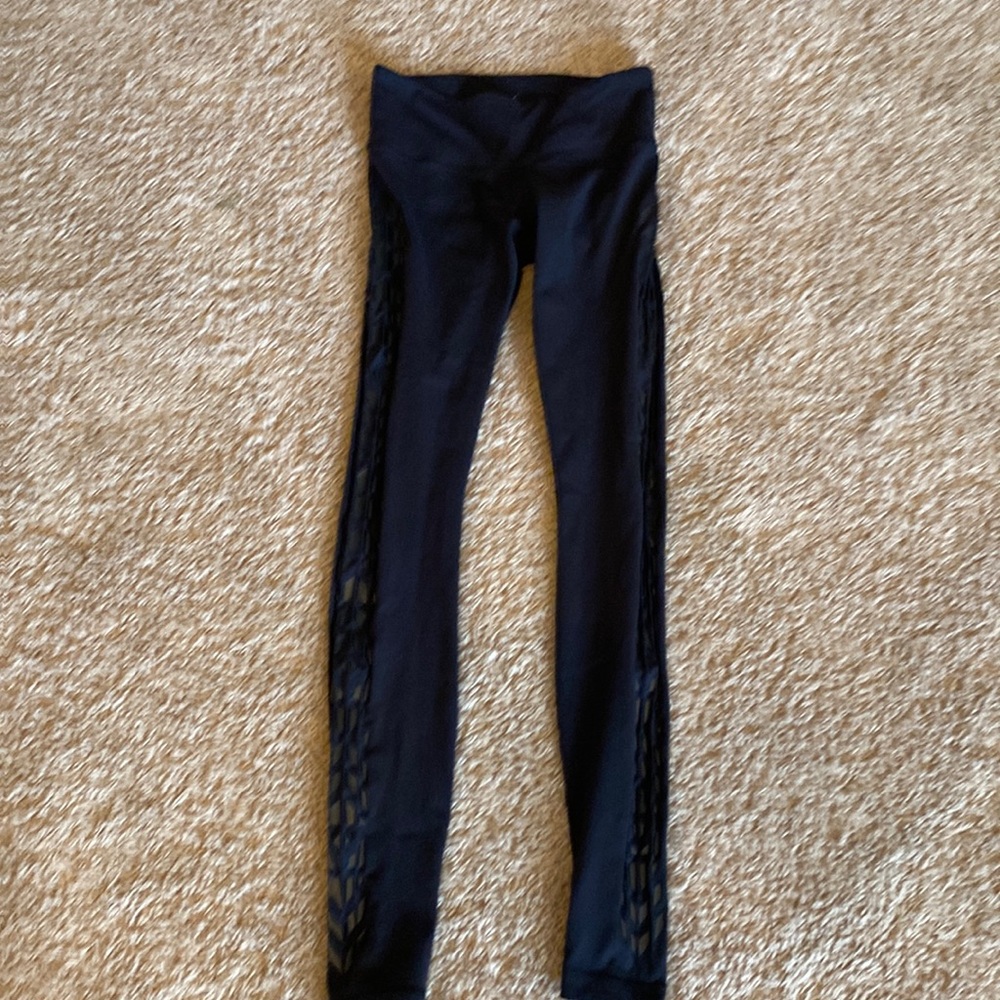 Lululemon black leggings size 4 with a design on the side.